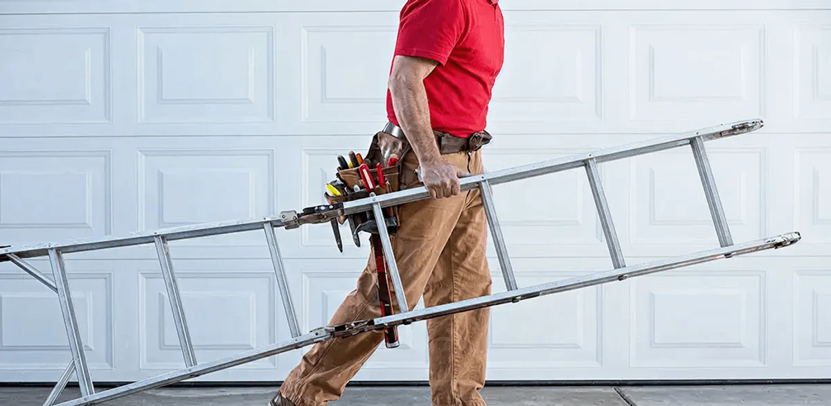Garage door repair technician arriving with tools and ladder in Boulder, CO