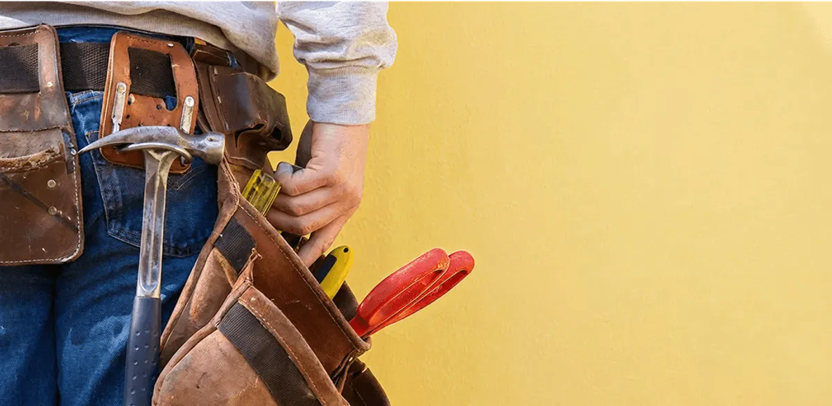 Handyman with tool belt ready for home repairs and maintenance in Boulder, CO